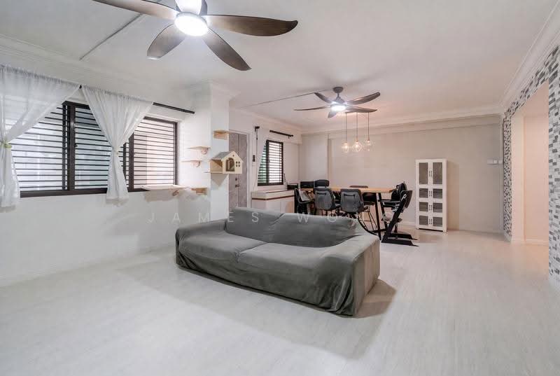 Living and dining area with a dining table, sofa and windows along one side