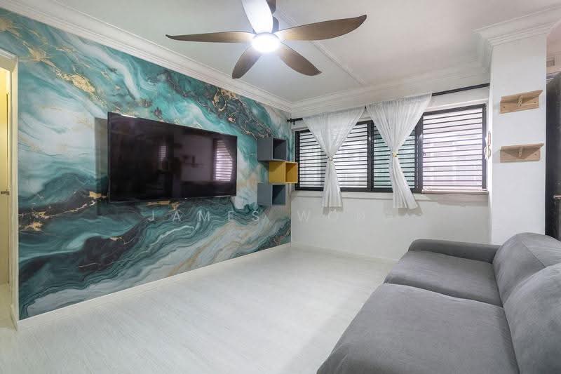Living room with a marbled feature wall, television and grey sofa